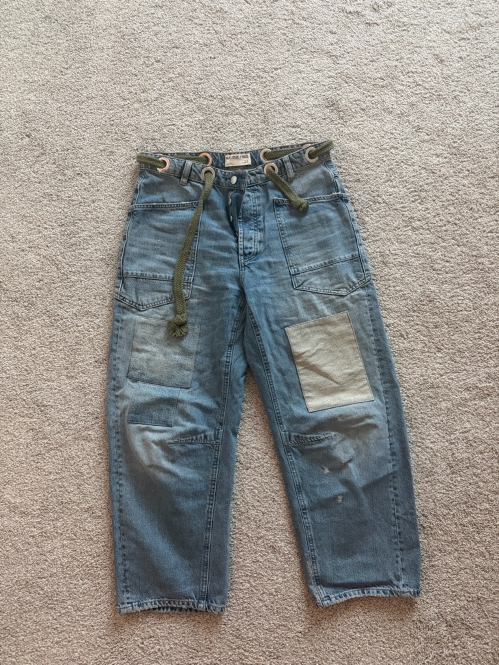 We The Free blue denim jeans with olive rope grommets